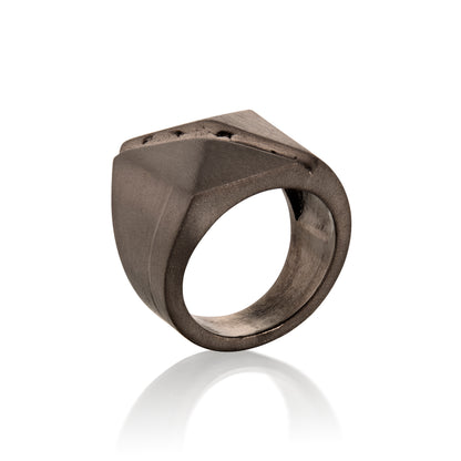 Black Geometric ring in 14k Gold with a geometric design on a white background