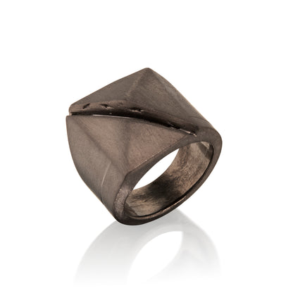 Bronze ring in 14k Gold with geometric design on a white background