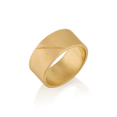 Gold band ring with an etched scar on a white background