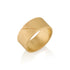 Gold band ring with an etched scar on a white background