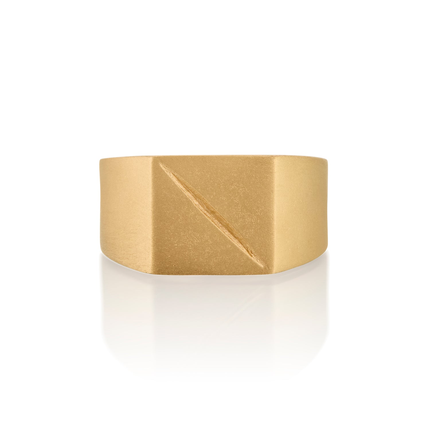 Gold ring 14k with a square face with an etched scar on a white background