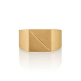 Gold ring 14k with a square face with an etched scar on a white background