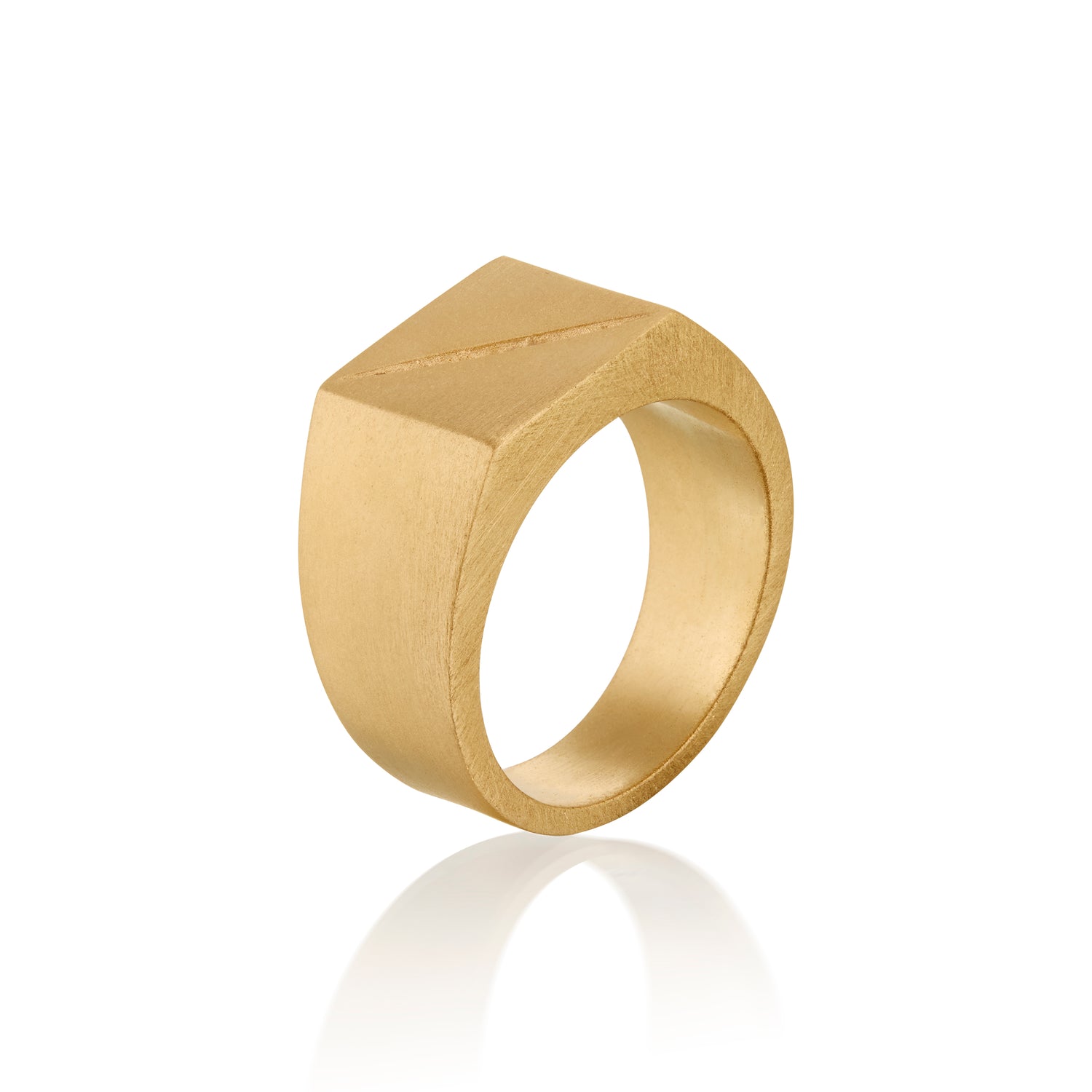 Gold ring with geometric design on a white background