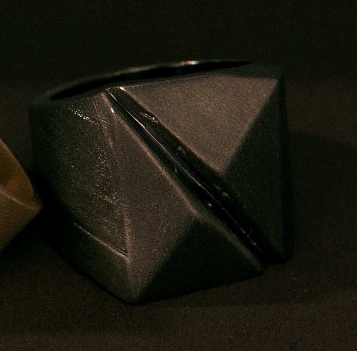 Black geometric ring on a dark background part of the SCAR / 01 Collection from MZNR